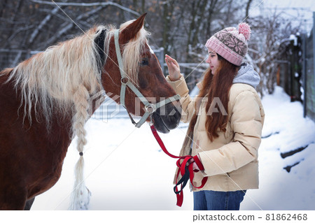 girl with long brown hair and chestnut horse with plaited mane close up portrait on winter snowy background girl with long brown hair and chestnut horse with plaited mane close up portrait on winter snowy background 81862468