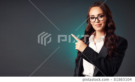 Portrait of a beautiful European businesswoman of the 30s in official clothes and glasses pointing Portrait of a beautiful European businesswoman of the 30s in official clothes and glasses pointing 81863104