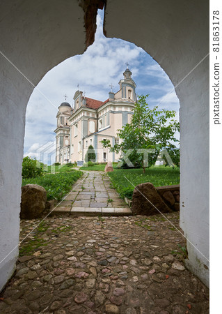 Old catholic church of St Judas Thaddeus in Luchai village, Vitebsk region, Postavy district, Belarus. View through a stone arch. Old catholic church of St Judas Thaddeus in Luchai village, Vitebsk region, Postavy district, Belarus. View through a stone arch. 81863178