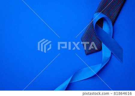 Prostate awareness. Blue ribbon, fashion tie isolated on deep blue background. Awareness prostate cancer of men health in November. Healthcare, International men, Father day. Prostate awareness. Blue ribbon, fashion tie isolated on deep blue background. Awareness prostate cancer of men health in November. Healthcare, International men, Father day. 81864616