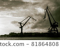 A monochrome image of Gothenburgs harbor entrance and silhuettes of two cranes 81864808