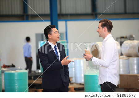 Happy business people talking on meeting at factory industry or Mature company manager greeting a worker  in industrial facility or warehouse 81865575