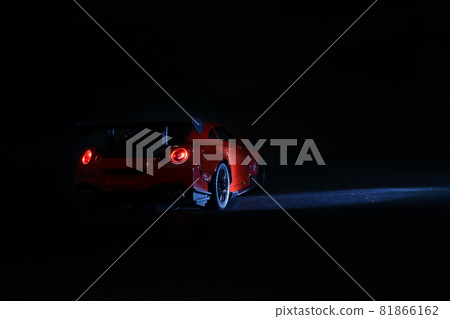 Modern red sports car metallic on black 81866162