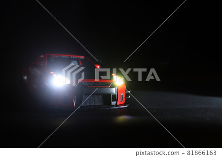 Modern red sports car metallic on black 81866163