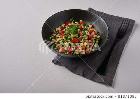 Traditional salad tabbouleh made of bulgur or couscous and vegetables 81871085