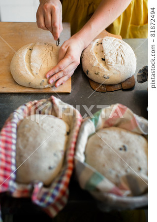 Girl baker cuts bread blank blade 81872494