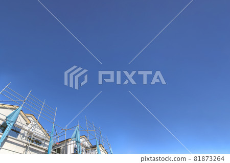 Wooden single-family house under construction against a blue sky with copy space, background, materials 81873264