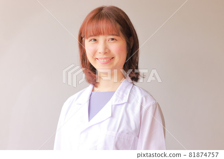 A smiling white coat woman 81874757
