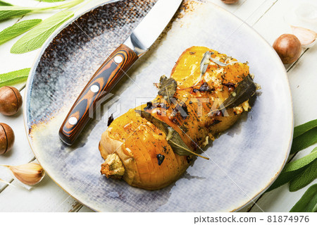 Baked pumpkin with herbs 81874976