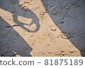 Shadow of a couple making a heart on a sandy beach 81875189