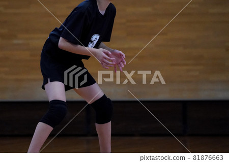 A player preparing to receive after a volleyball serve has been hit 81876663