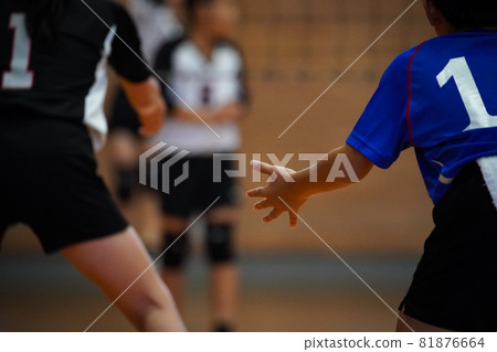 A player preparing to receive after a volleyball serve has been hit A player preparing to receive after a volleyball serve has been hit 81876664