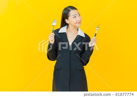 Portrait beautiful young asian woman smile with spoon and fork 81877774
