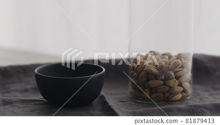 salted pistachios with black bowl on linen cloth salted pistachios with black bowl on linen cloth 81879413