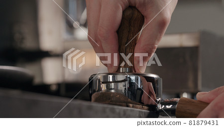 tamping fresh ground coffee in basket of bottomless portafilter tamping fresh ground coffee in basket of bottomless portafilter 81879431