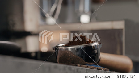 fresh ground coffee in basket of bottomless portafilter fresh ground coffee in basket of bottomless portafilter 81879434