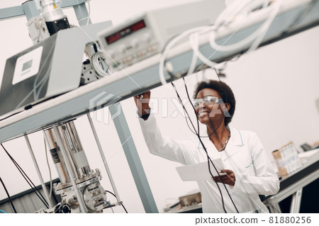 Scientist african american woman working in laboratory with electronic instruments Scientist african american woman working in laboratory with electronic instruments 81880256