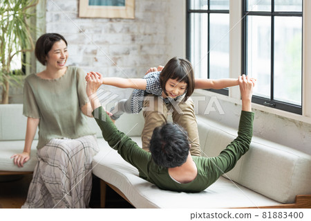 Girl playing with dad at home Girl playing with dad at home 81883400