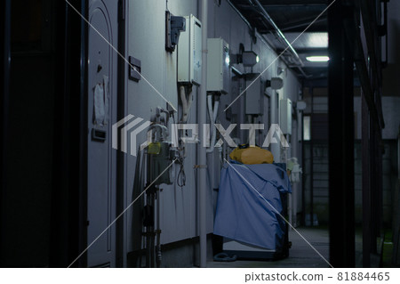Old apartment walkway at night 81884465
