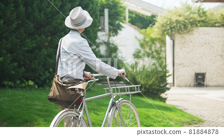 Senior man cycling pushing a bicycle 81884878