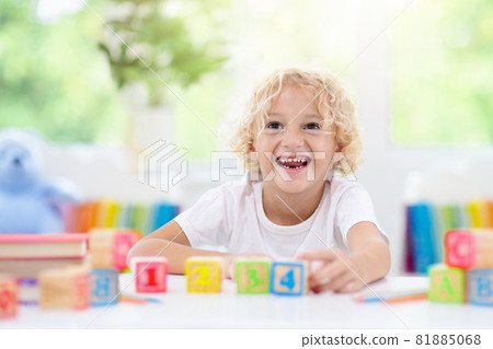Child learning letters. Kid with wooden abc blocks 81885068