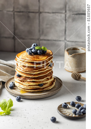 Stack of pancakes with syrup and blueberry on the table Stack of pancakes with syrup and blueberry on the table 81885687
