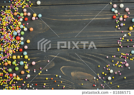 Colorful Foam ball on a black wooden background Colorful Foam ball on a black wooden background 81886571
