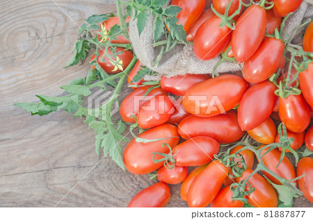 Fresh, ripe tomatoes on wood background Fresh, ripe tomatoes on wood background 81887877