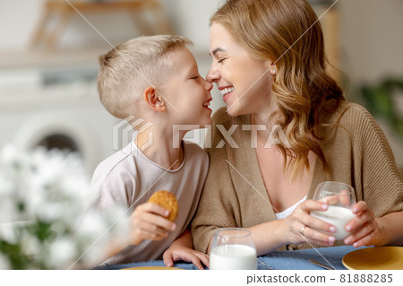 Happy mother and son touching noses during breakfast Happy mother and son touching noses during breakfast 81888285