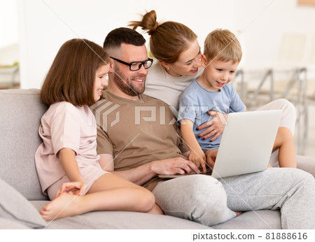 Young beautiful family using modern technologies while spending time together at home 81888616