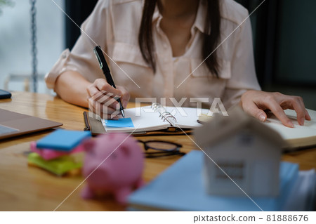Business woman or broker checking contract agreement paper with customer to sign contract. Real Estate and Agreement concept 81888676