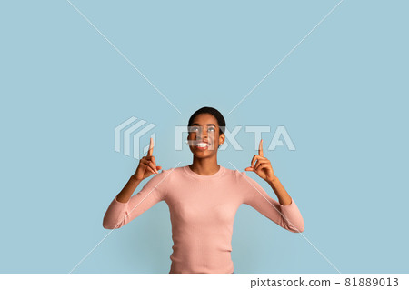 Check This. Cheerful Happy Excited Black Female Pointing Up At Copy Space 81889013