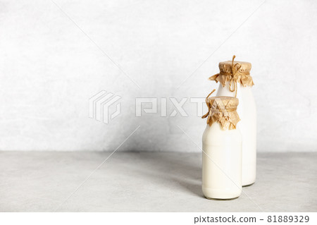 Non dairy plant based milk in bottles and ingredients on light background. Alternative lactose free milk substitute Non dairy plant based milk in bottles and ingredients on light background. Alternative lactose free milk substitute 81889329