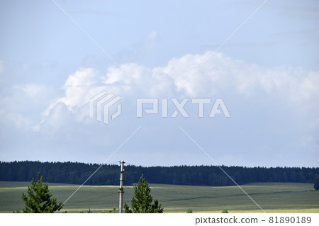 Blue and white cumulus clouds before a thunderstorm on the horizon Blue and white cumulus clouds before a thunderstorm on the horizon 81890189