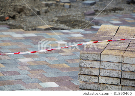 Process of construction of brick paved sidewalk, half built pavement road 81890460