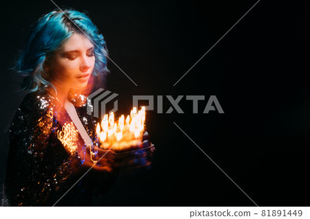 Festive bakery. Smiling woman. Party organization. Advertising background. Inspired dreamful lady holding sweet cake with candle lights long exposure isolated black copy space. Festive bakery. Smiling woman. Party organization. Advertising background. Inspired dreamful lady holding sweet cake with candle lights long exposure isolated black copy space. 81891449