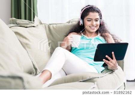 Woman watching videos on digital tablet 81892162