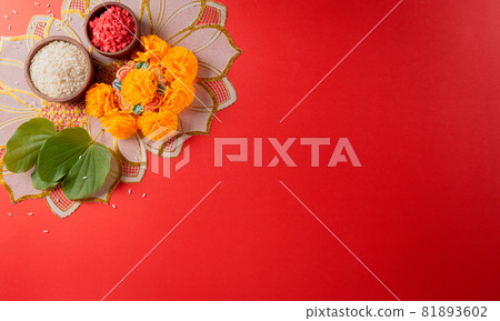 Happy Dussehra. Yellow flowers, green leaf and rice on red background. Dussehra Indian Festival concept. Happy Dussehra. Yellow flowers, green leaf and rice on red background. Dussehra Indian Festival concept. 81893602