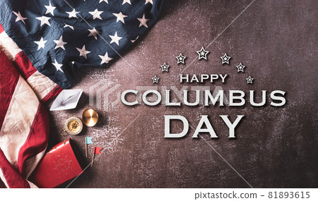 Happy Columbus Day concept. Vintage American flag, compass, paper boat, rope with the text on dark stone background. Happy Columbus Day concept. Vintage American flag, compass, paper boat, rope with the text on dark stone background. 81893615