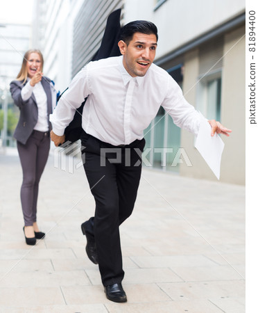 Adult employee is running away with documants from his female boss Adult employee is running away with documants from his female boss 81894400