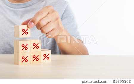 Hand putting wood cube block increasing on top with icon percentage symbol upward direction 81895508