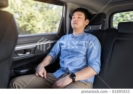 man sleeping while sitting in the back seat of car man sleeping while sitting in the back seat of car 81895833