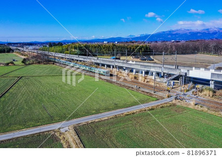 Tohoku Main Line running on the sunny Nasu Plateau, Tohoku Main Line and Mt. Nasu, drone photo, 81896371