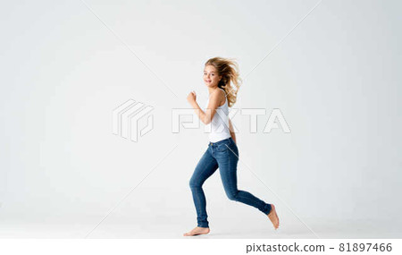 woman in jeans barefoot Positive light motion background woman in jeans barefoot Positive light motion background 81897466