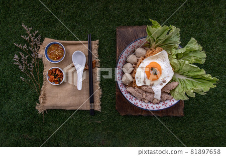 Egg noodles soup with pork ball, minced pork, fried egg, vegetables and soups in bowl. Egg noodles soup with pork ball, minced pork, fried egg, vegetables and soups in bowl. 81897658