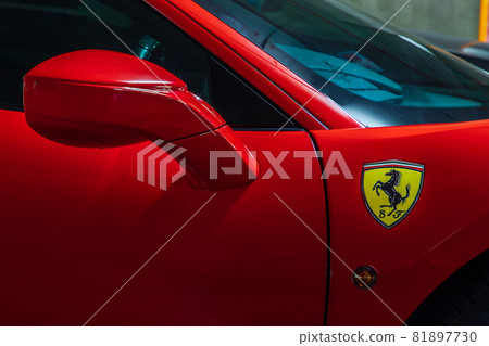 Close-up of Side view mirror and Logo Ferrari Sports Car. 81897730