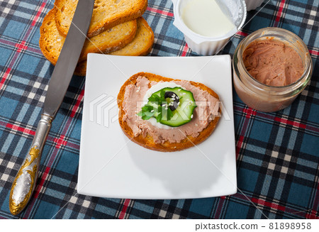 Canape with pate and young cheese and tomatoe at bread, served on desk 81898958