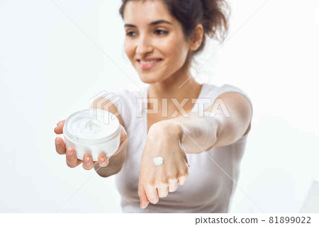 woman in white t-shirt cream jar skin care moisturizing dermatology woman in white t-shirt cream jar skin care moisturizing dermatology 81899022