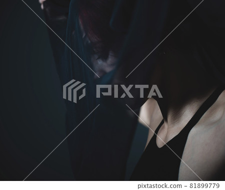 Profile of a woman in a black veil. Costume Dead bride for Halloween. Portrait of an evil grinning Witch in front of a coven. 81899779