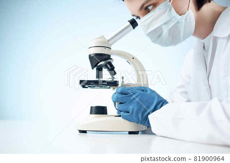 woman in laboratory looking through microscope close-up biotechnology science 81900964